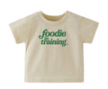 “foodie in training” Baby Cream T-Shirt